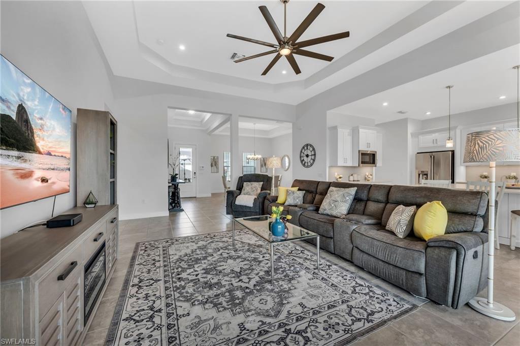3410 Wellfleet Lane Naples, FL 34114 - Photo 6 of 28 a living room with furniture and a flat screen tv