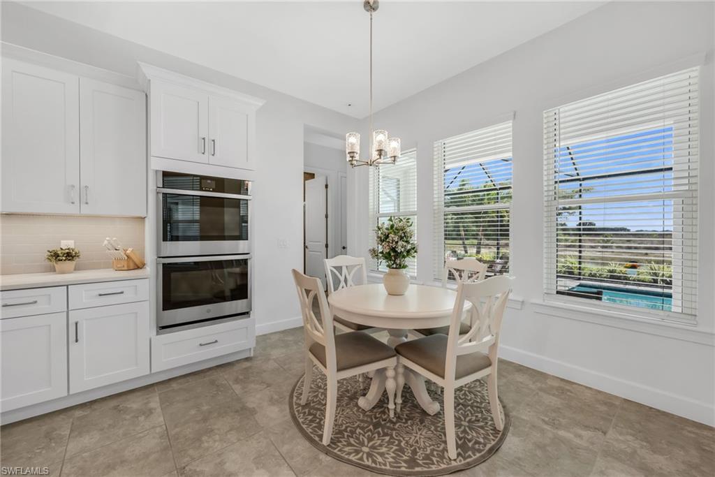 3410 Wellfleet Lane Naples, FL 34114 - Photo 7 of 28 a dining room with furniture and window