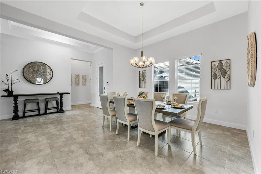 3410 Wellfleet Lane Naples, FL 34114 - Photo 8 of 28 a view of a dining room that has a table and chairs