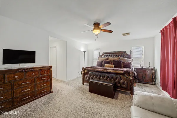 a bedroom with a bed and a television