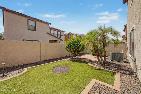 a view of a backyard with plants and patio