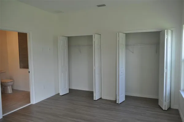 a view of a room with wooden floor