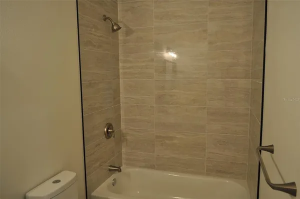 a bathroom with a shower and a toilet