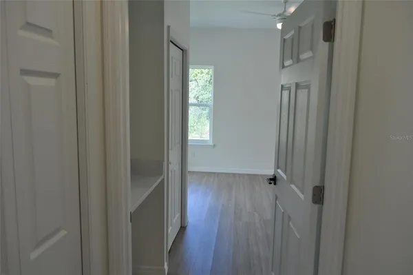 a view of hallway with wooden floor
