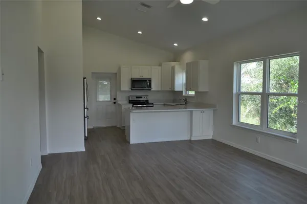 a kitchen with stainless steel appliances granite countertop a stove a sink and a refrigerator