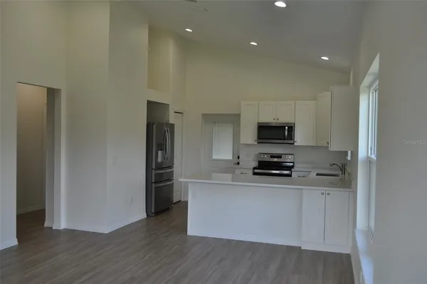 a kitchen with stainless steel appliances granite countertop a stove and a refrigerator