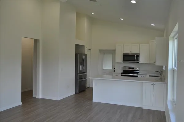 a kitchen with stainless steel appliances a refrigerator and a stove top oven