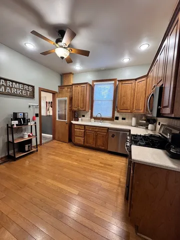 a view of kitchen with sink microwave and cabinets