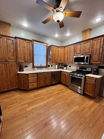 a view of a livingroom with wooden floor and workspace