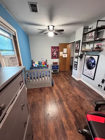 a bedroom with a bed and a chandelier