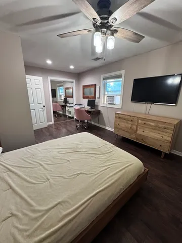a bedroom with a bed and a large mirror