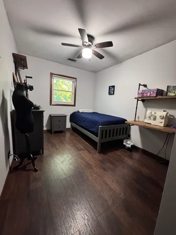 a room with a black white checkered floor with a large mirror and sink