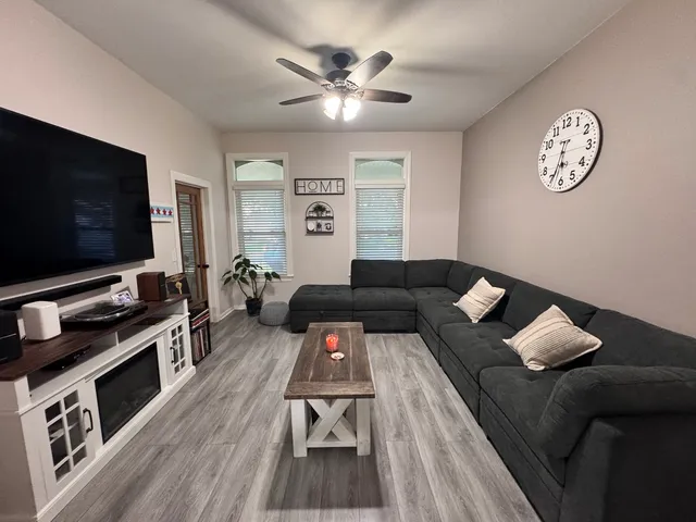 a living room with furniture and a flat screen tv