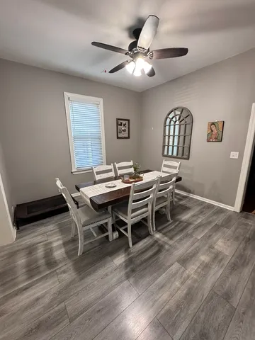 a dining room with a wooden table and chairs