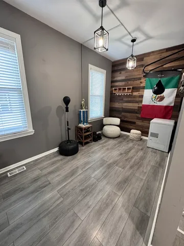 a bedroom with furniture and wooden floor