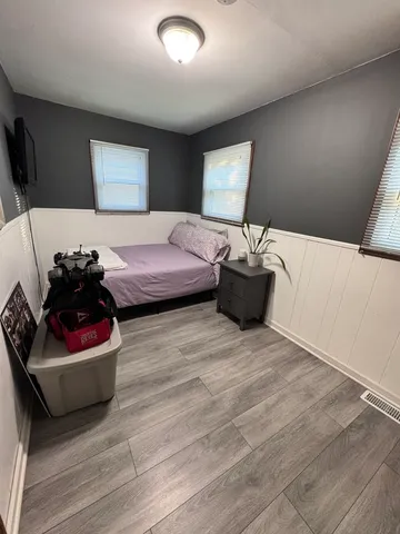 a bedroom with furniture and a flat screen tv