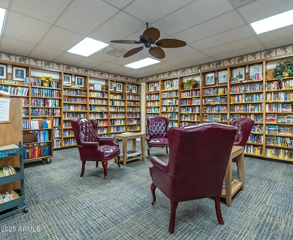 a large room with pool table a fireplace and a chandelier