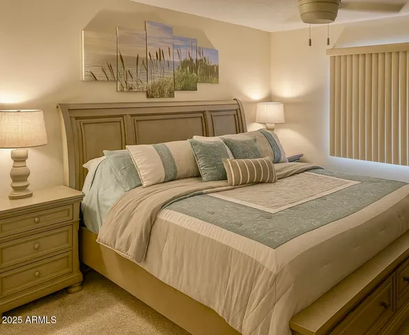 a bedroom with a bed and a night stand