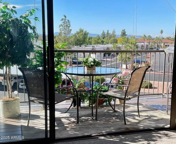 a view of a chairs and table in patio