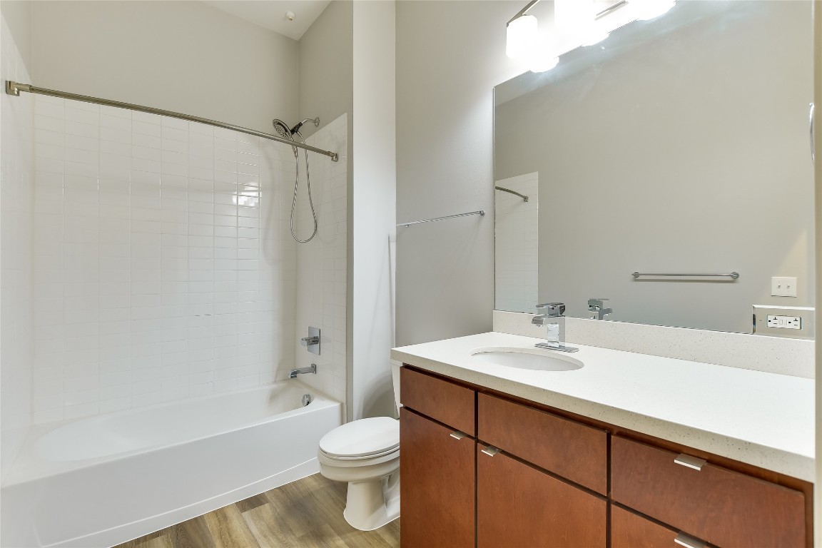 507 Sabine Street, Unit 709 Austin, TX 78701 - Photo 12 of 13 Full bathroom with vanity, bathing tub / shower combination, and light wood-style floors