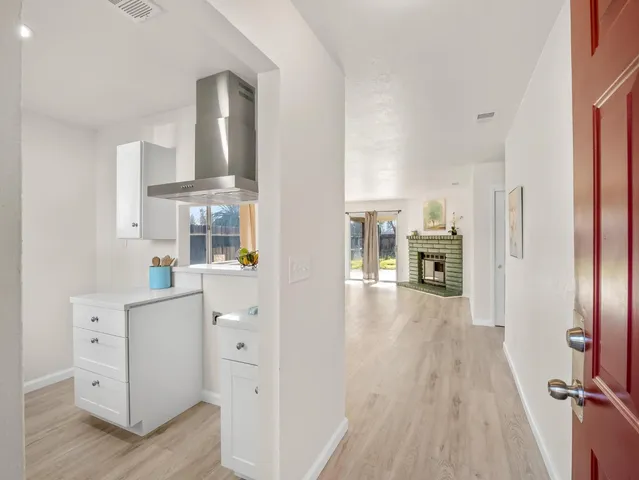 a view of living room with furniture and wooden floor