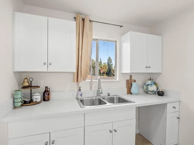 a kitchen with a sink cabinets and window