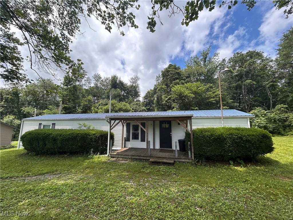 78790 Hamilton Ridge Road Freeport, OH 43973 - Photo 1 of 17 Manufactured / mobile home with covered porch, a front yard, and a metal roof