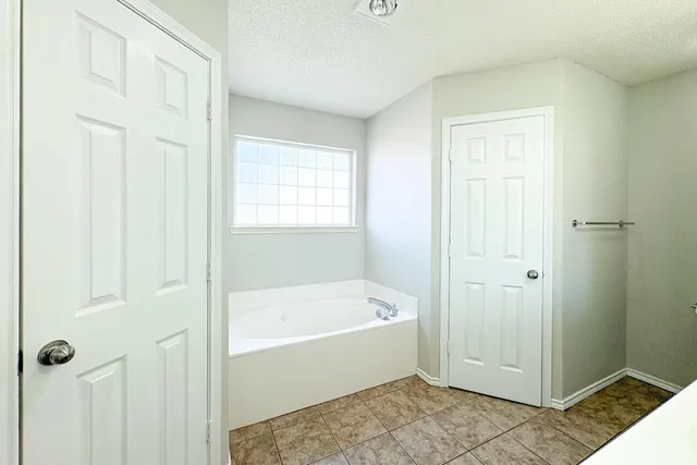 a bathroom with a bathtub and shower