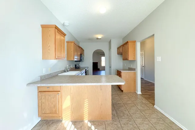 a view of a kitchen with a sink and a living room view