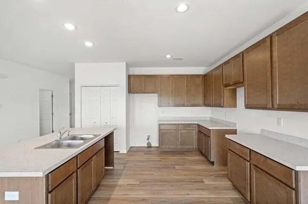 a kitchen with a sink and wooden cabinets