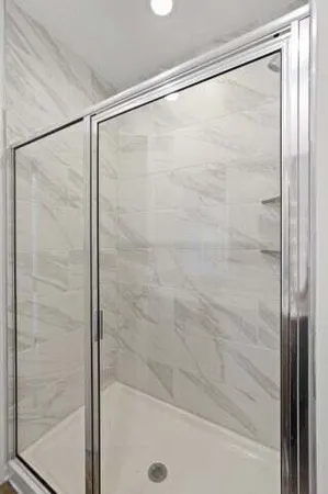 a bathroom with a glass shower door