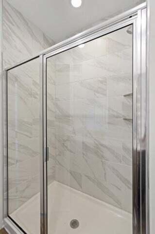 6641 East 103rd Avenue Crown Point, IN 46307 - Photo 10 of 11 a bathroom with a glass shower door