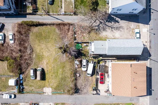 an aerial view of a house with a yard