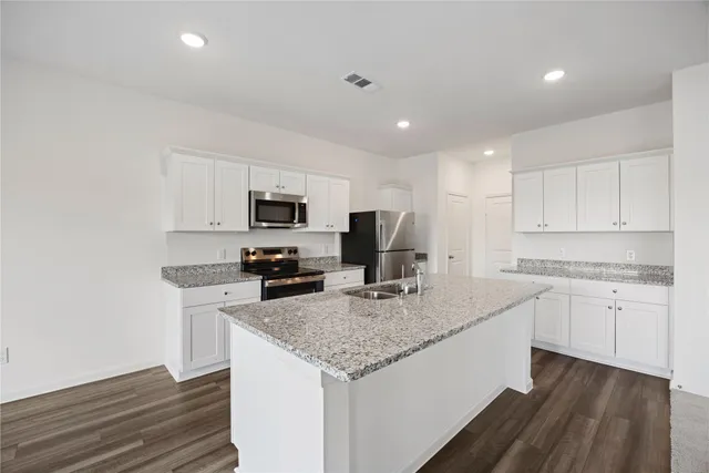 a view of a backyard with a garden and deck