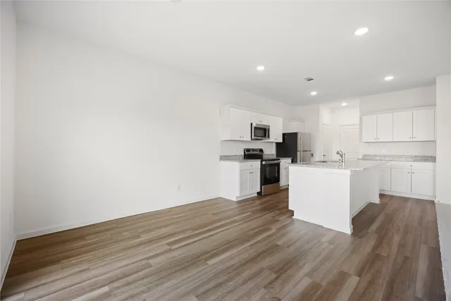 a view of kitchen with wooden floor