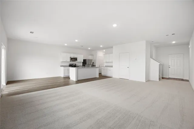 a view of a kitchen with a sink and a refrigerator