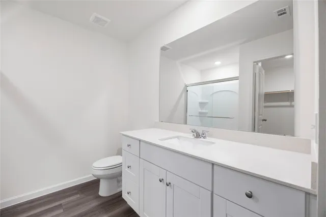 a view of empty room with kitchen and window