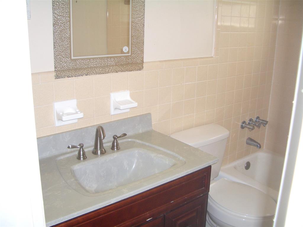 2737 Northeast 28th Street, Unit 7W Lighthouse Point, FL 33064 - Photo 6 of 15 a bathroom with a sink and a toilet