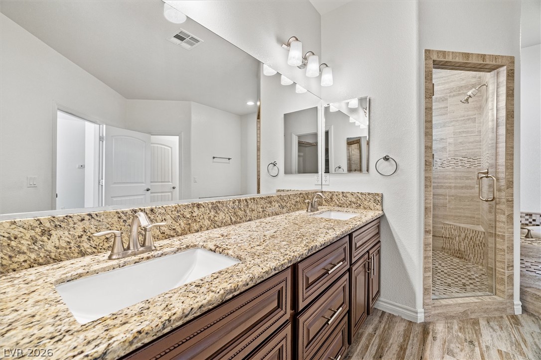 6720 Stubblefield Drive Pahrump, NV 89061 - Photo 29 of 51 Dual vanities with granite counters complement the generously sized walk-in shower.