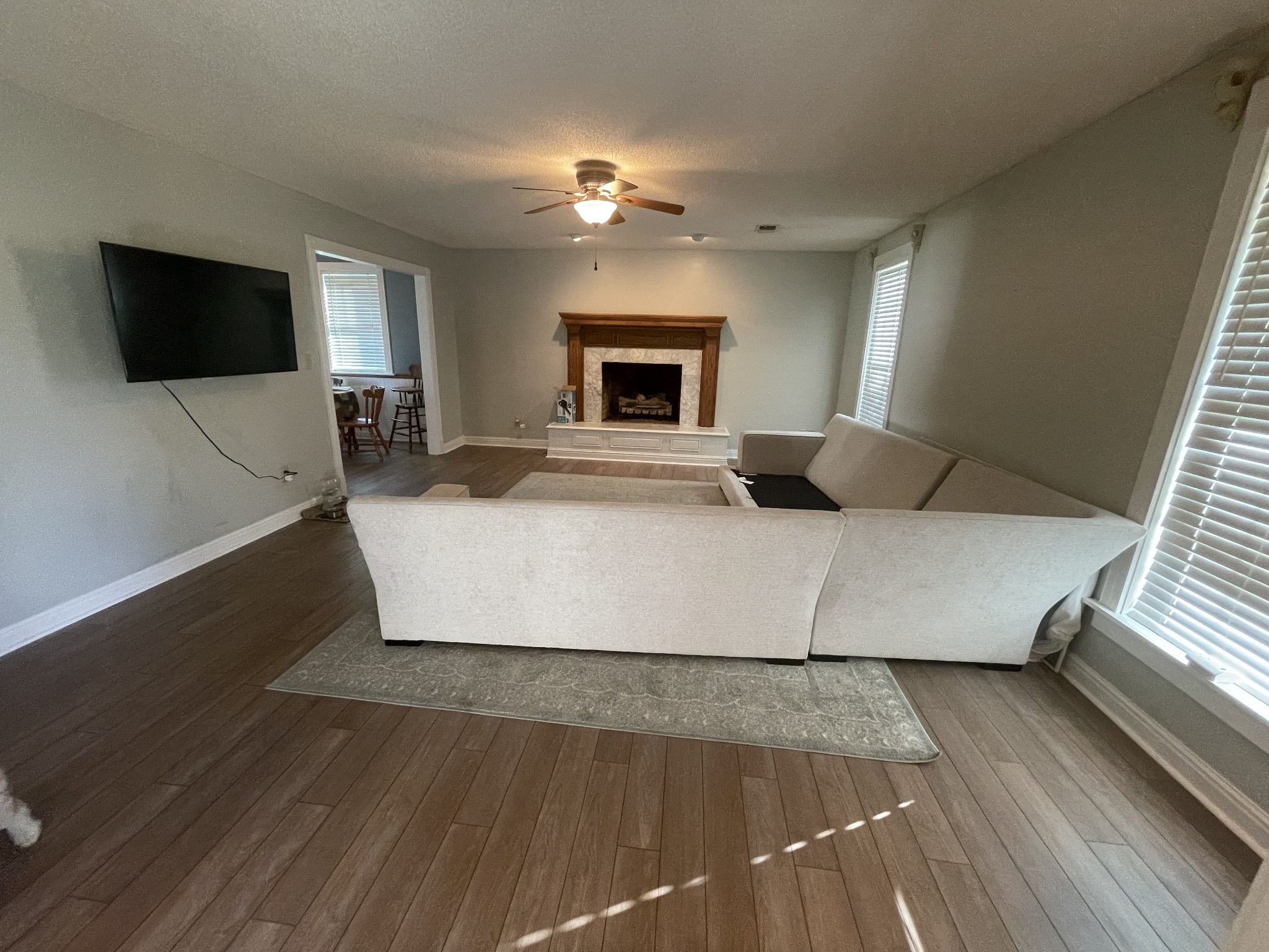 109 Walnut Grove Road Lebanon, TN 37090 - Photo 6 of 19 a large bed sitting in a living room next to a window with a flat screen tv