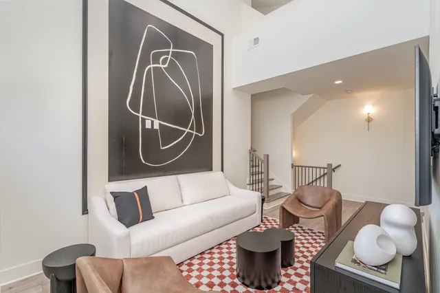 a living room with furniture and a mirror