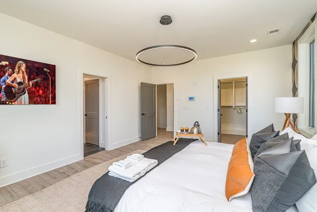 a bedroom with a bed and a painting on the wall