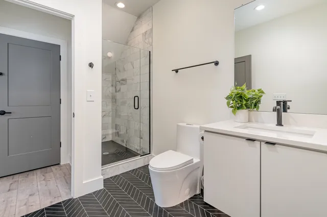 a bathroom with a sink toilet and shower