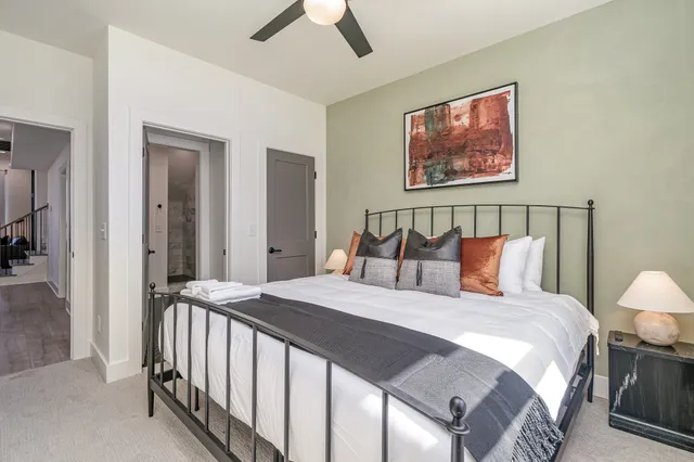 a bedroom with a bed and a painting on the wall