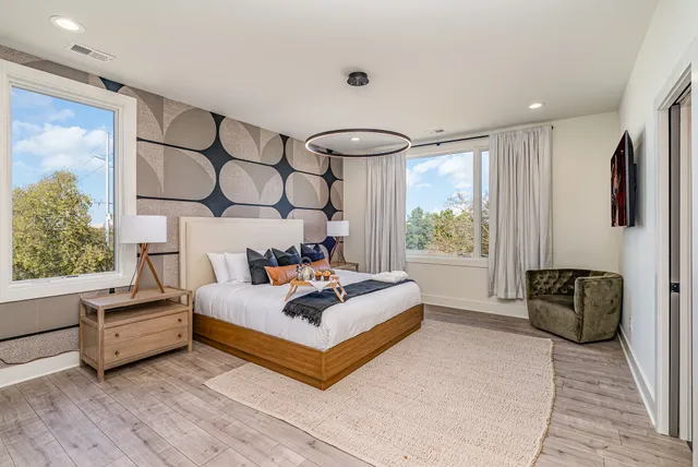 a spacious bedroom with a bed and a large window