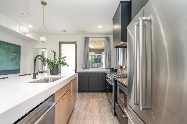 a kitchen with a sink appliances and cabinets