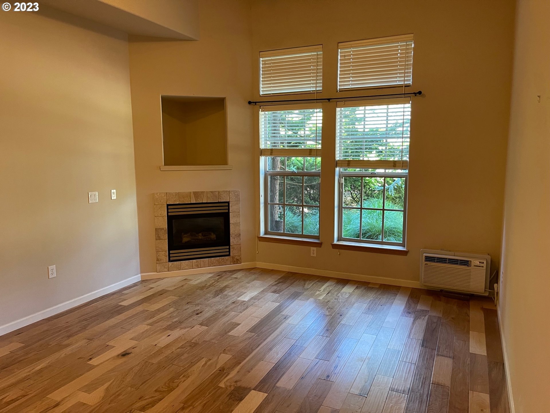 20512 Southwest Roy Rogers Road, Unit 112 Sherwood, OR 97140 - Photo 11 of 18 a view of an empty room with wooden floor and a window