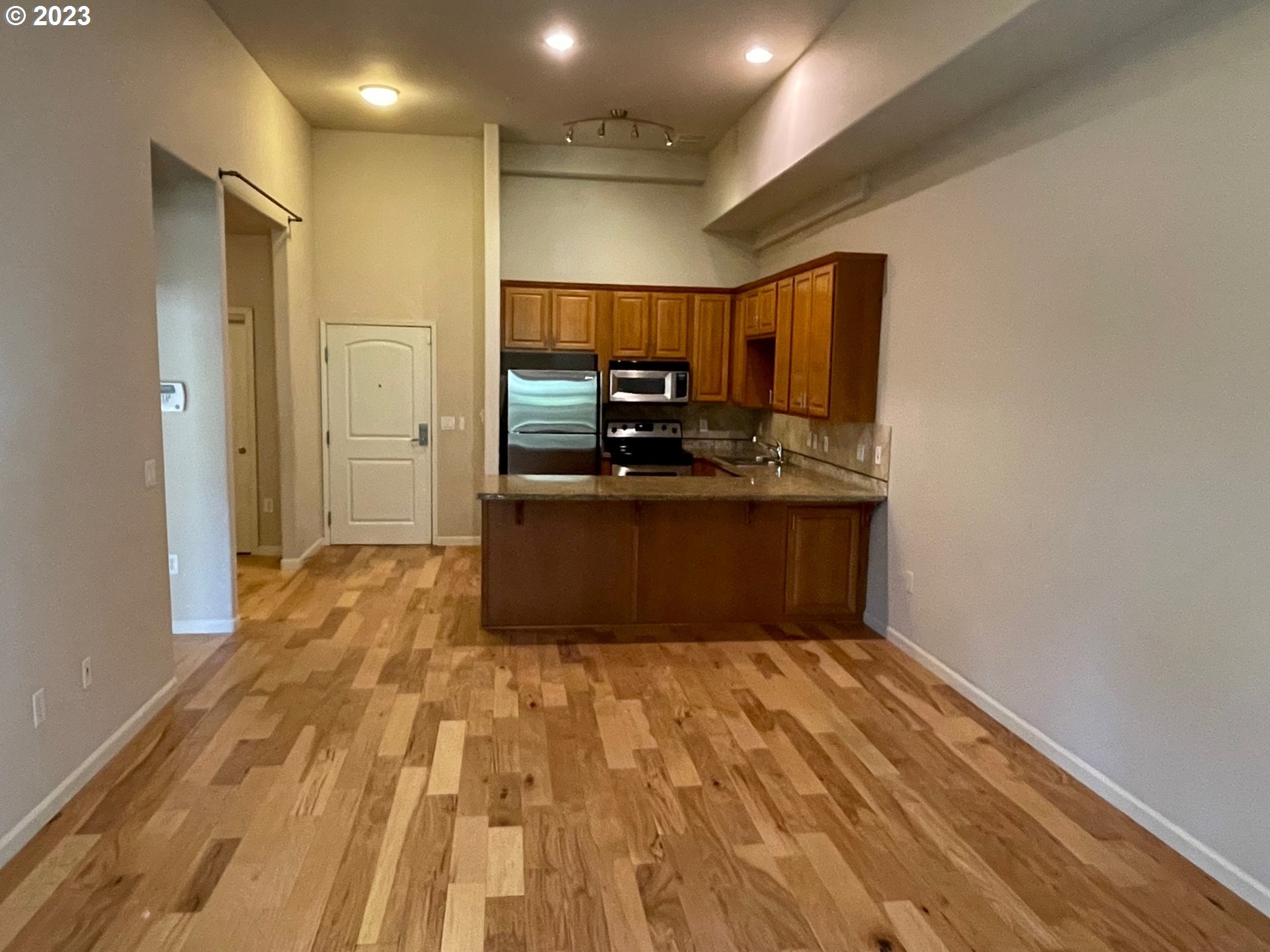 20512 Southwest Roy Rogers Road, Unit 112 Sherwood, OR 97140 - Photo 12 of 18 a kitchen with stainless steel appliances a sink and a refrigerator