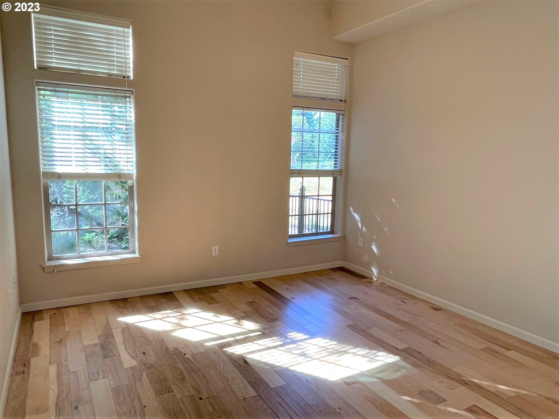 20512 Southwest Roy Rogers Road, Unit 112 Sherwood, OR 97140 - Photo 13 of 18 an empty room with wooden floor and windows