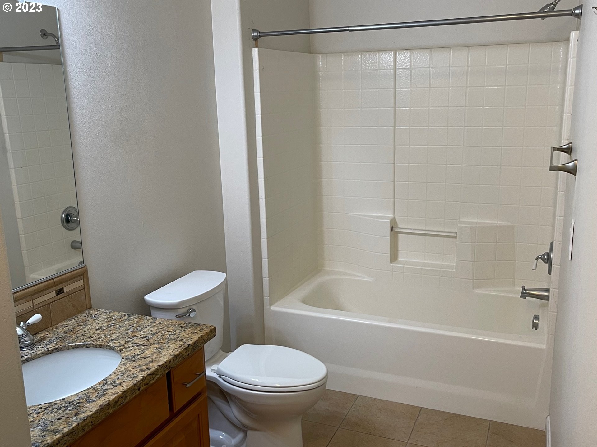 20512 Southwest Roy Rogers Road, Unit 112 Sherwood, OR 97140 - Photo 15 of 18 a bathroom with a granite countertop sink toilet and shower